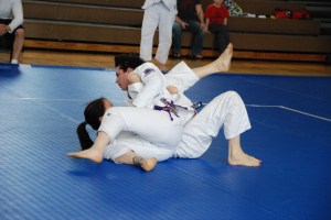 Crossing over is part of the fun. Jujitsuka Lori Porsch (BETA) pins Judoka Jenae Michell (DC Judo) in a Judo match.